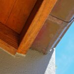 Detailed close-up shot of old, weathered roof shingles showing cracks and moss, symbolizing the need for roof inspection a...