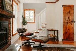 Professional homeowner thoughtfully reviewing architectural blueprints inside a bright, modern home, symbolizing strategic...